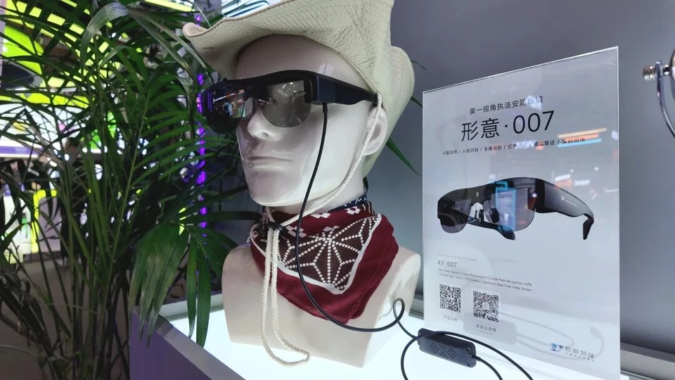 Physical Falcon 007 Pro reference glasses on a display mannequin, side view showing the cable and inline controller